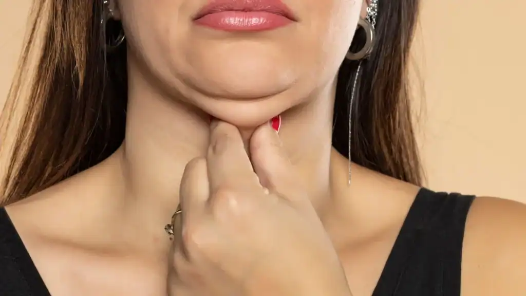 An image of a woman with double chin, sad, worried : Non Surgical Double Chin Removal Treatment in Stoulton, UK